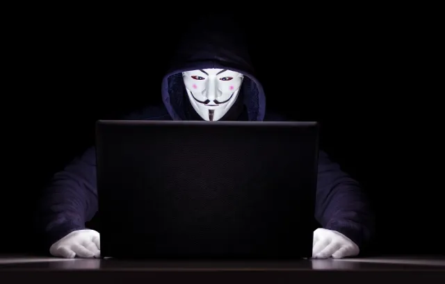 hacker-white-mask-on-working-at-computer-data-security-ciphertex-data-storage-united-states