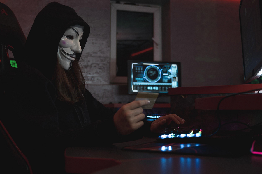 girl hecker in white mask while doing cyber crimes