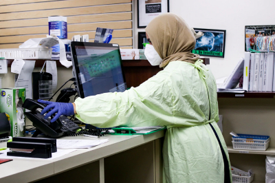 female-scientist-in-protective-gear-answering-phone-data-security-ciphertex-data-storage-united-states